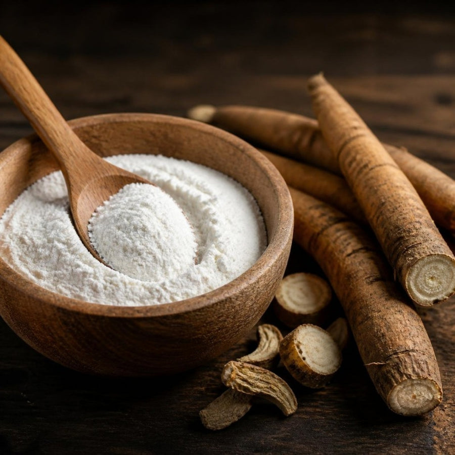 White inulin powder in a wooden bowl with chicory roots