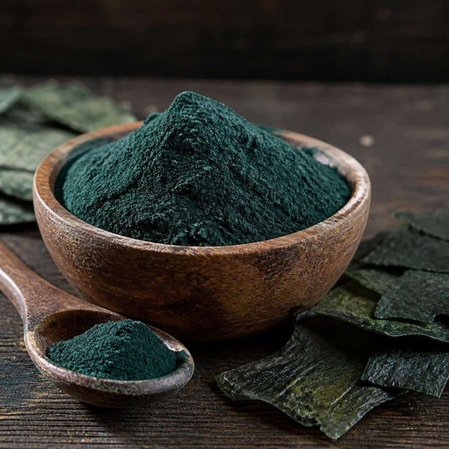 Dark green spirulina powder in a wooden bowl